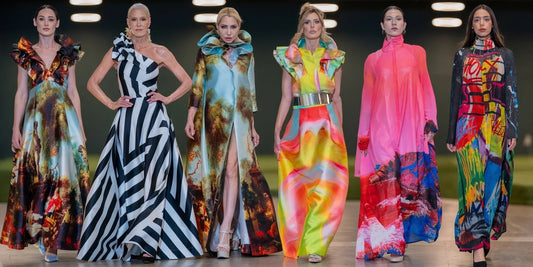 Six models wearing colourful maxjenny! dresses and coats with bold prints on the runway